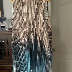 Zip up long tunic style vest. Turquoise,cream,and black with black faux leather.
